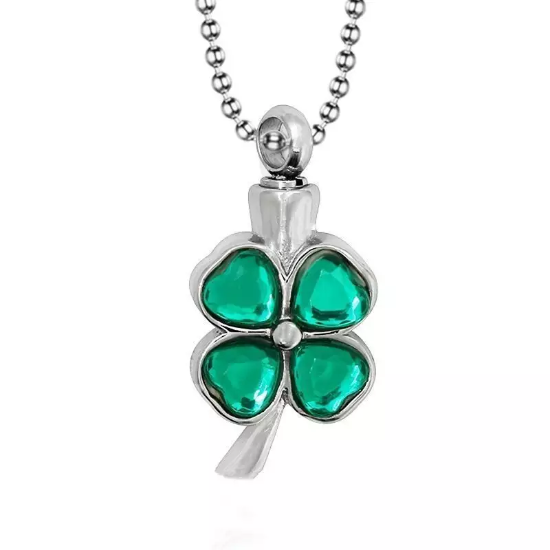 Green clover cremation necklace with a white background.