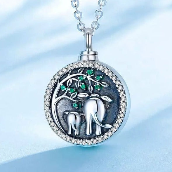 Main Image of a cremation necklace that shows 2 elephants with a tree containing green stones.