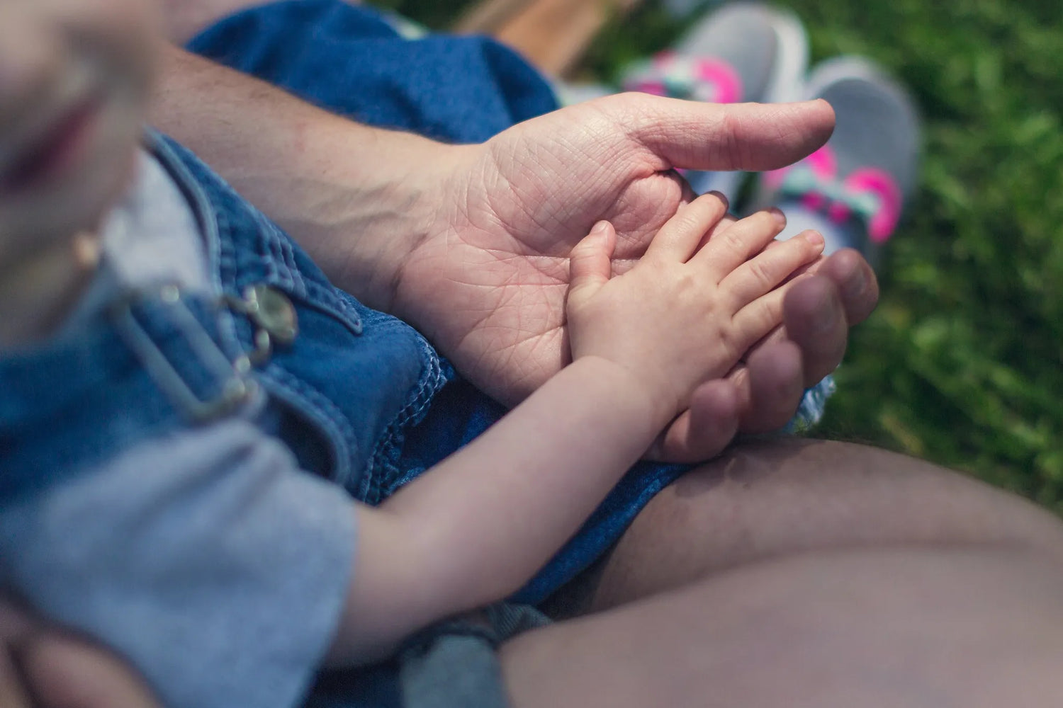 Man holding hands with baby